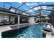 A screened swimming pool is surrounded by lounge areas, a fountain, and lush landscaping creating a serene outdoor space at 14285 United Colonies Dr, Winter Garden, FL 34787
