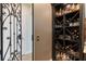 Wine cellar with wrought iron gate and bottle rack storage for wines and spirits at 14285 United Colonies Dr, Winter Garden, FL 34787