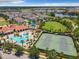 Aerial view of community pool, tennis courts, clubhouse and green space at 14639 Winter Stay Dr, Winter Garden, FL 34787