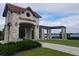Stone Watermark entrance with tile roof and pergola overlooking the lake at 14639 Winter Stay Dr, Winter Garden, FL 34787