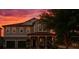 Charming two-story home with a spacious front yard and two-car garage at dusk at 14639 Winter Stay Dr, Winter Garden, FL 34787