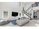 Bright living room with a staircase, large tv, and comfortable seating, perfect for entertaining at 14639 Winter Stay Dr, Winter Garden, FL 34787