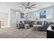 Cozy living room featuring an oversized sectional sofa, plush carpet, and natural lighting at 14639 Winter Stay Dr, Winter Garden, FL 34787