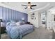 Elegant main bedroom featuring an accent wall, plush carpet, and a seamless flow to adjacent living spaces at 14639 Winter Stay Dr, Winter Garden, FL 34787