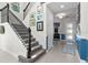 Elegant staircase with dark iron railings and carpeted steps, leading to the upper level at 14639 Winter Stay Dr, Winter Garden, FL 34787