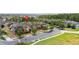 Community aerial view showing well maintained lawns, palms, and nearby woods at 14706 Driftwater Dr, Winter Garden, FL 34787