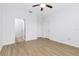 Bedroom with wood-look floors, ceiling fan, and doorways to the bathroom and closet at 14706 Driftwater Dr, Winter Garden, FL 34787