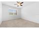 Cozy bedroom with a large window and neutral carpet flooring at 14706 Driftwater Dr, Winter Garden, FL 34787