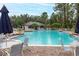 Inviting community pool surrounded by tables, chairs, and lush landscaping offering a relaxing and social atmosphere at 14706 Driftwater Dr, Winter Garden, FL 34787