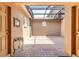 A covered patio with brick flooring sits between two doors offering shade and weather protection at 14706 Driftwater Dr, Winter Garden, FL 34787
