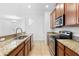 Spacious kitchen showcasing granite countertops and stainless steel appliances at 14706 Driftwater Dr, Winter Garden, FL 34787