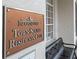 Community center sign on the building's exterior with a nearby bench at 14706 Driftwater Dr, Winter Garden, FL 34787