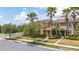 Beautiful street view of townhomes featuring well-manicured lawns, verdant trees, and vibrant landscaping at 14706 Driftwater Dr, Winter Garden, FL 34787