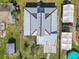 Drone shot of house with a silver roof and backyard with a pool, yard and buildings at 1511 New York Ave, St Cloud, FL 34769