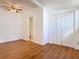Bedroom with light wood flooring, closet and doorway to bathroom at 1511 New York Ave, St Cloud, FL 34769