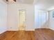 Bedroom with light wood flooring, closet and doorway to bathroom at 1511 New York Ave, St Cloud, FL 34769