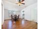 Open-concept dining area features beautiful wood floors, neutral walls, and views into the kitchen at 1511 New York Ave, St Cloud, FL 34769