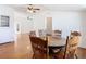 Inviting dining area with hardwood flooring, neutral walls, and a classic wooden table with chairs at 1511 New York Ave, St Cloud, FL 34769