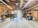 View of a garage interior showing exposed wooden beams, concrete floors, and natural lighting at 1511 New York Ave, St Cloud, FL 34769