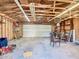 Interior view of a spacious garage with exposed beams and concrete floors at 1511 New York Ave, St Cloud, FL 34769