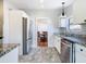 Kitchen with white cabinets, stainless steel appliances and view to dining area at 1511 New York Ave, St Cloud, FL 34769
