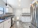Updated kitchen with granite countertops, stainless steel appliances, white cabinets, and tile floors at 1511 New York Ave, St Cloud, FL 34769