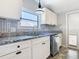 Modern kitchen featuring granite countertops, sleek appliances, and clean white cabinetry at 1511 New York Ave, St Cloud, FL 34769