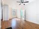 Spacious living room with wood floors and white walls accented by natural light from windows at 1511 New York Ave, St Cloud, FL 34769