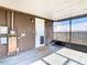 Covered patio area with peeling paint and an external door at 1511 New York Ave, St Cloud, FL 34769