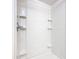 Shower stall featuring white tiled walls and built-in shelving at 1511 New York Ave, St Cloud, FL 34769