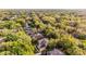 Breathtaking aerial view of the property surrounded by a canopy of trees and a lush yard at 162 Seville Chase Dr, Winter Springs, FL 32708