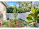 Landscaped backyard area features a white fence, stepping stones and garden at 162 Seville Chase Dr, Winter Springs, FL 32708