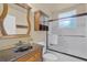 Bathroom featuring a vanity with a granite countertop and a shower with a glass door at 162 Seville Chase Dr, Winter Springs, FL 32708