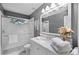 Bright bathroom featuring a marble vanity, glass shower and a large mirror at 162 Seville Chase Dr, Winter Springs, FL 32708