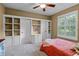 Comfortable bedroom with white built-ins, a window with shutters, and neutral carpet at 162 Seville Chase Dr, Winter Springs, FL 32708