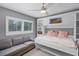 Functional bedroom with a gray sofa, built-in shelving, and a Murphy bed at 162 Seville Chase Dr, Winter Springs, FL 32708