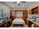 Bedroom featuring custom wood shelving, desk space, and neutral decor at 162 Seville Chase Dr, Winter Springs, FL 32708