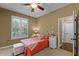 Charming bedroom featuring a bright window and floral headboard with coordinating pillows at 162 Seville Chase Dr, Winter Springs, FL 32708