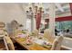 Formal dining area with ample seating, chandelier, and views into the living room and outside at 162 Seville Chase Dr, Winter Springs, FL 32708
