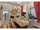 Elegant dining room with a chandelier, designer furniture and a glimpse of the adjacent living area at 162 Seville Chase Dr, Winter Springs, FL 32708