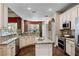 Well-lit kitchen featuring granite countertops, stainless steel appliances, and views of the backyard at 162 Seville Chase Dr, Winter Springs, FL 32708