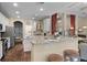 Bright, well-lit kitchen with a breakfast bar, stainless steel appliances, and a view into the living room at 162 Seville Chase Dr, Winter Springs, FL 32708