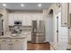 Kitchen featuring stainless steel refrigerator and plenty of cabinet space for storage at 162 Seville Chase Dr, Winter Springs, FL 32708