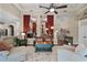 Open-concept living area showcasing coffered ceilings, stylish columns, and seamless flow to the dining room at 162 Seville Chase Dr, Winter Springs, FL 32708