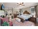 Bright main bedroom with ceiling fan, ornate wood accents, and views into the bathroom at 162 Seville Chase Dr, Winter Springs, FL 32708