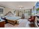 Stately main bedroom showcasing a wooden bed frame, hard wood floors, and plantation shutters at 162 Seville Chase Dr, Winter Springs, FL 32708