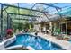 Backyard with screened pool, outdoor seating, and mature landscaping offers a private retreat at 162 Seville Chase Dr, Winter Springs, FL 32708