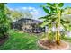 Aerial view of the screened pool with lush landscaping and mature trees at 162 Seville Chase Dr, Winter Springs, FL 32708