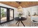 The dining area seamlessly combines modern lighting, wooden ceiling details, and an adjacent backyard at 1701 Canton Street, Orlando, FL 32803
