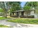 Charming single Gathering home showcasing lush landscaping, mature trees, and a welcoming front porch at 1701 Canton Street, Orlando, FL 32803